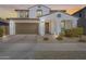 Two-story house with brown garage door and landscaping at 14428 W Faye Way, Surprise, AZ 85387