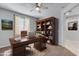 Bright home office with built-in shelving and a large desk at 14428 W Faye Way, Surprise, AZ 85387
