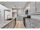 Modern kitchen featuring gray cabinets and granite countertops at 14428 W Faye Way, Surprise, AZ 85387