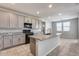 Modern kitchen with gray cabinets, granite counters, and an island at 14428 W Faye Way, Surprise, AZ 85387