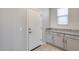 Laundry room with gray cabinets and granite countertop at 14428 W Faye Way, Surprise, AZ 85387