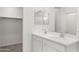 Bathroom with double vanity, white cabinets, and a large mirror at 1615 S 239Th Dr, Buckeye, AZ 85326