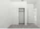 Bedroom with sliding closet doors and carpet at 1615 S 239Th Dr, Buckeye, AZ 85326
