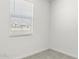 Bright bedroom with neutral walls and gray carpet at 1615 S 239Th Dr, Buckeye, AZ 85326