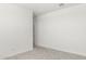 Simple bedroom with neutral walls and carpet, featuring a door to hallway at 1615 S 239Th Dr, Buckeye, AZ 85326