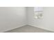 Empty bedroom with neutral walls and gray carpet at 1615 S 239Th Dr, Buckeye, AZ 85326