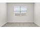 Bright bedroom with neutral walls and carpet, featuring a window with blinds at 1615 S 239Th Dr, Buckeye, AZ 85326
