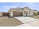 New construction home with a two-car garage and neutral exterior at 1615 S 239Th Dr, Buckeye, AZ 85326