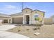 Newly built home featuring a two-car garage and drought-tolerant landscaping at 1615 S 239Th Dr, Buckeye, AZ 85326