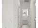 Bright hallway with doors to bedrooms and a window at 1615 S 239Th Dr, Buckeye, AZ 85326