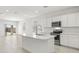 Modern kitchen with white cabinets, stainless steel appliances, and an island at 1615 S 239Th Dr, Buckeye, AZ 85326