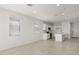 Open concept living room with kitchen and tile floors at 1615 S 239Th Dr, Buckeye, AZ 85326