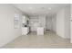 Open concept living room with kitchen and tile floors at 1615 S 239Th Dr, Buckeye, AZ 85326