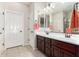 Double vanity bathroom with dark wood cabinets at 16711 S 178Th Dr, Goodyear, AZ 85338