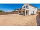 Spacious backyard with a large patio and desert landscaping at 1702 W Flintlock Dr, San Tan Valley, AZ 85144