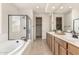 Spa-like bathroom with double vanity, soaking tub, and walk-in shower at 1702 W Flintlock Dr, San Tan Valley, AZ 85144
