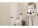 Elegant powder room with pedestal sink and frameless mirror at 1702 W Flintlock Dr, San Tan Valley, AZ 85144