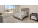 Bright bedroom with plush bed and large window overlooking backyard at 1702 W Flintlock Dr, San Tan Valley, AZ 85144