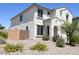 Two-story house with tan exterior, two-car garage, and desert landscaping at 1702 W Flintlock Dr, San Tan Valley, AZ 85144