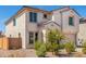 Two-story house with light-beige exterior, two-car garage, and landscaping at 1702 W Flintlock Dr, San Tan Valley, AZ 85144