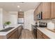 Open kitchen with stainless steel appliances and wood cabinets at 1702 W Flintlock Dr, San Tan Valley, AZ 85144