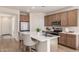 Modern kitchen island with stainless steel appliances and wood cabinets at 1702 W Flintlock Dr, San Tan Valley, AZ 85144