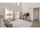 Bright living room with high ceilings, sliding glass doors, and hardwood floors at 1702 W Flintlock Dr, San Tan Valley, AZ 85144
