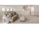Spacious living room with a couch and ottoman at 1702 W Flintlock Dr, San Tan Valley, AZ 85144