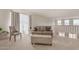 Bright living room with a sofa and ottoman at 1702 W Flintlock Dr, San Tan Valley, AZ 85144