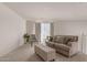 Cozy living room featuring a sofa and ottoman at 1702 W Flintlock Dr, San Tan Valley, AZ 85144
