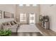 Spacious living area featuring hardwood floors, large windows, and neutral decor at 1702 W Flintlock Dr, San Tan Valley, AZ 85144