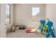 Spacious playroom with large window, carpet flooring, and ' toys at 1702 W Flintlock Dr, San Tan Valley, AZ 85144