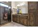 Bathroom with double sinks, granite countertops, and a walk-in shower at 1713 E Amaranth Trl, Queen Creek, AZ 85140