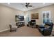 Bedroom features a large TV, comfortable seating, and natural light at 1713 E Amaranth Trl, Queen Creek, AZ 85140