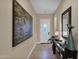Bright and airy entryway with tile flooring, large art piece, and console table at 1713 E Amaranth Trl, Queen Creek, AZ 85140