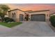 Attractive curb appeal featuring a gray garage and well-manicured lawn at 1713 E Amaranth Trl, Queen Creek, AZ 85140