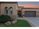 House exterior featuring a two-car garage and landscaping at 1713 E Amaranth Trl, Queen Creek, AZ 85140