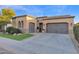 House exterior with a two-car garage and manicured lawn at 1713 E Amaranth Trl, Queen Creek, AZ 85140