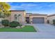 House exterior with a two-car garage and manicured lawn at 1713 E Amaranth Trl, Queen Creek, AZ 85140