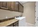 Bright laundry room, featuring granite countertops and ample cabinetry at 1713 E Amaranth Trl, Queen Creek, AZ 85140