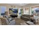 Comfortable living room with a large TV, neutral color scheme, and access to backyard at 1713 E Amaranth Trl, Queen Creek, AZ 85140