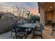 Spacious backyard patio with seating area, water feature, and dining table at 1713 E Amaranth Trl, Queen Creek, AZ 85140