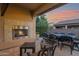 Outdoor patio with fireplace, seating area, and water feature at 1713 E Amaranth Trl, Queen Creek, AZ 85140