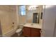 Bathroom with single vanity, tub, and updated fixtures at 17263 W Elm St, Surprise, AZ 85388