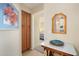 View of bedroom from hallway, showing a wooden cabinet and decorative mirror at 18431 N Coconino Dr, Surprise, AZ 85374