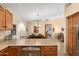 Eat-in kitchen with stainless steel appliances and view into living room at 18431 N Coconino Dr, Surprise, AZ 85374