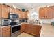 Kitchen boasts stainless steel appliances and ample cabinetry at 18431 N Coconino Dr, Surprise, AZ 85374