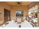 Covered patio with seating area, ceiling fan, and access to backyard at 18431 N Coconino Dr, Surprise, AZ 85374