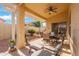 Relaxing covered patio with seating area and view of backyard at 18431 N Coconino Dr, Surprise, AZ 85374