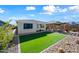 Landscaped backyard with pergola, artificial turf, and a cactus garden at 18956 W Laurel Ln, Surprise, AZ 85388